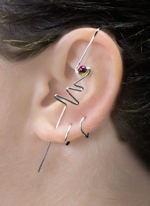 Ear of a model with a bolt design ear climber with squiggly design and a single bead. | Ear Curls, Ear Climbers