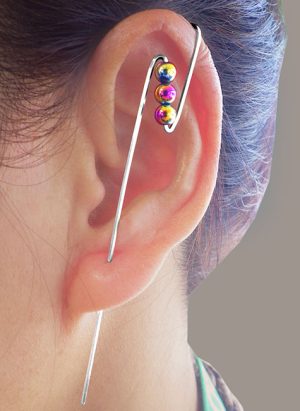 View of a models ear with a bolt ear climber with three beads on it. | Ear Curls, Ear Climbers