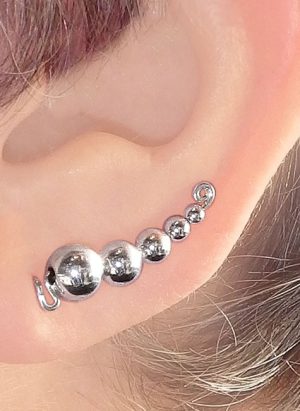 This ear climber earring has have silver beads all one size smaller than the next. Starting with the largest bead at the top and each next bead up is once size smaller. | Ear Curls, Ear Climbers