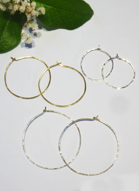 Three pairs of different sized hoop earrings, two in silver and one in yellow gold. | Ear Curls, Ear Climbers