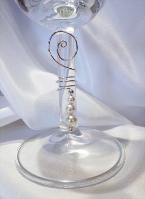 Stem of a wine glass with wedding charms with three pearls and a decorative loop at the top. | Ear Curls, Ear Climbers